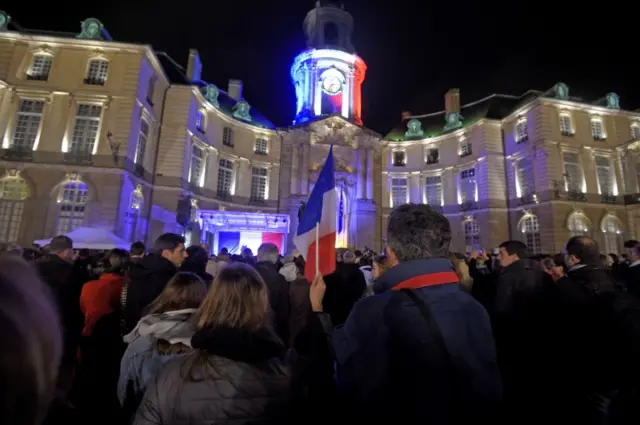 People gather to observe a minute of silence outside the Rennes city hall, western France