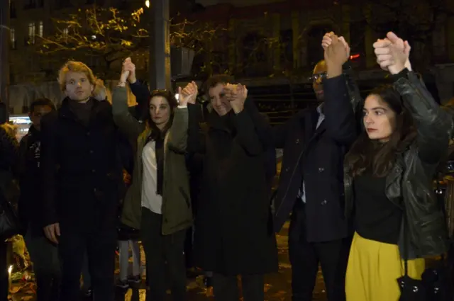 France's former minister of culture and current president of the Institute of the Arab World Jack Lang (centre) with others outside the Bataclan