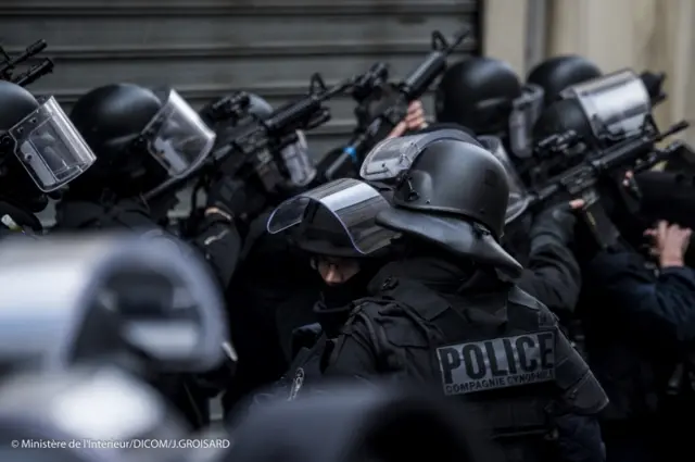 police raided a flat in a northern Paris suburb, leading to scenes that witnesses said resembled a warzone