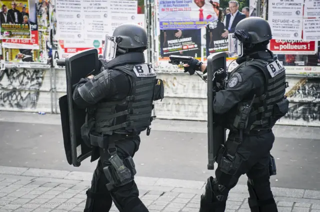 police raided a flat in a northern Paris suburb, leading to scenes that witnesses said resembled a warzone