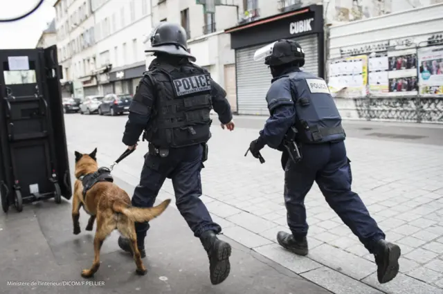 police raided a flat in a northern Paris suburb, leading to scenes that witnesses said resembled a warzone