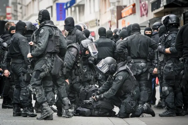 police raided a flat in a northern Paris suburb, leading to scenes that witnesses said resembled a warzone