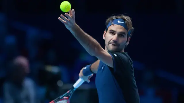 Roger Federer serves