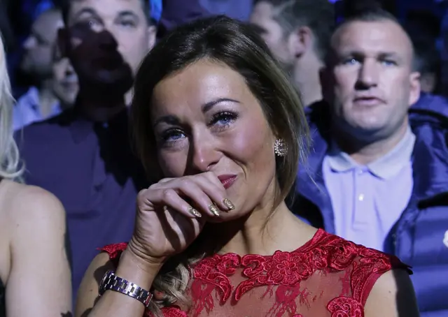 Gemma Murray watches her husband, Martin, enter the ring