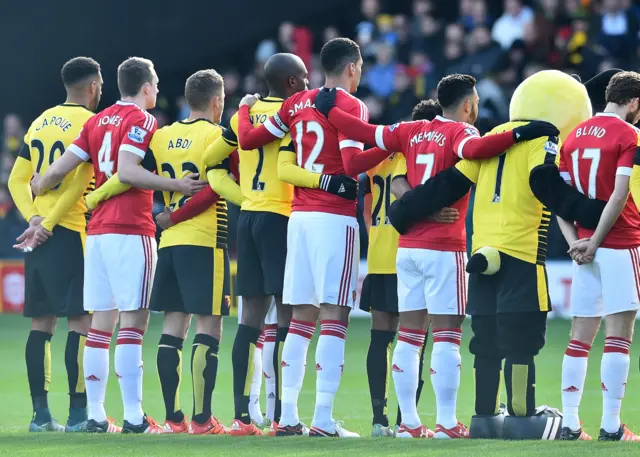 Players observe the French national anthem