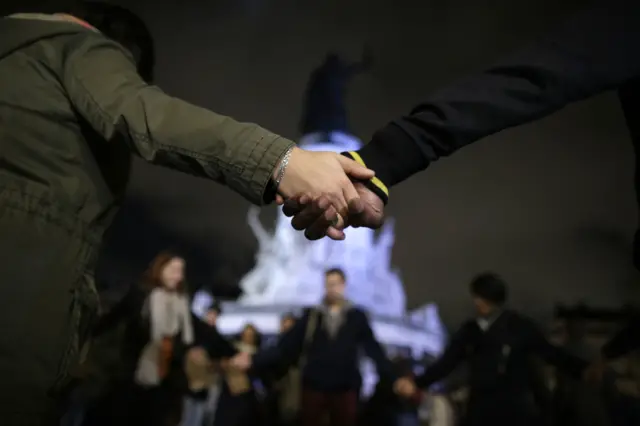 People holding hands at Place de la Republique