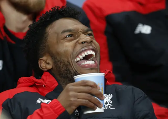 Daniel Sturridge laughs on the bench