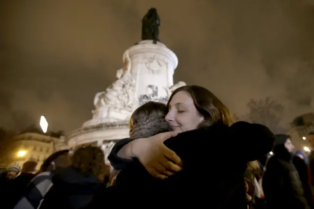 People hug at the Place de la Republique