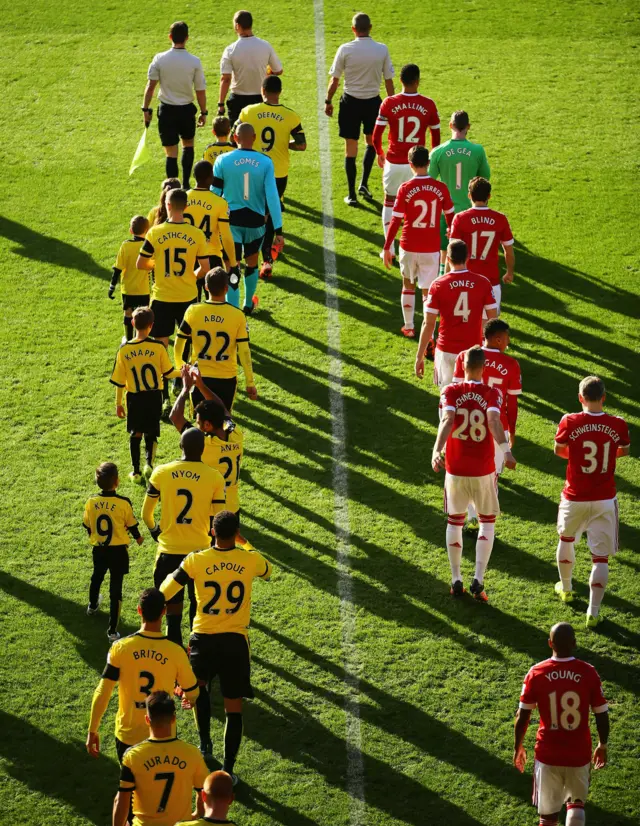 Players enter the pitch