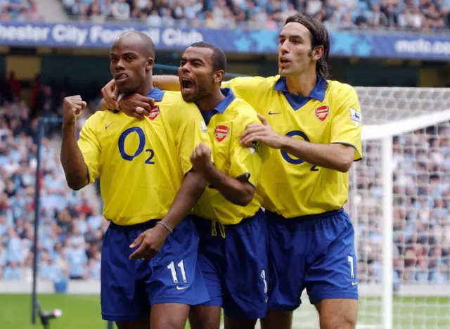 Sylvain Wiltord celebrates scoring against Manchester City in 2003