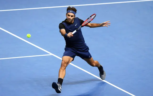 Roger Federer plays a volley