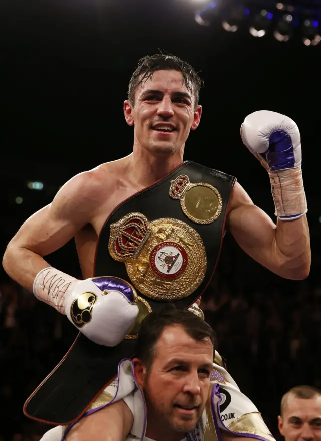 Anthony Crolla, on the shoulders of his trainer, celebrates his world title