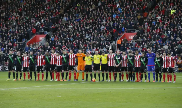 Southampton and Stoke players stand for the French national anthem