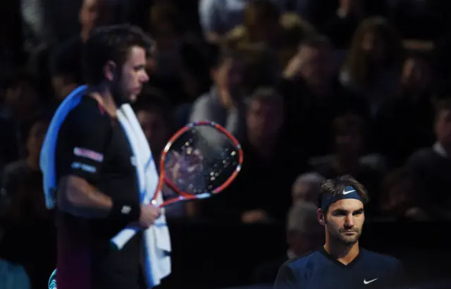 Roger Federer sits down during the change of ends