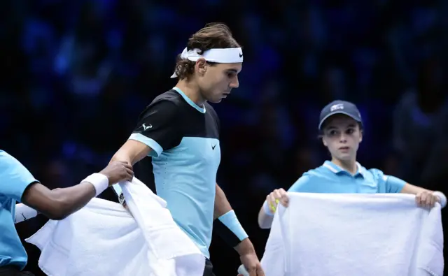 Rafael Nadal is given a towel