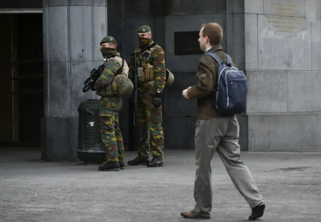 Soldiers stand outside the entrance of Brussels Central Station