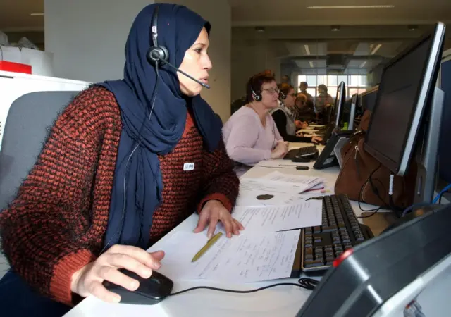 People People work at a crisis call center in Leuven, east of Brussels