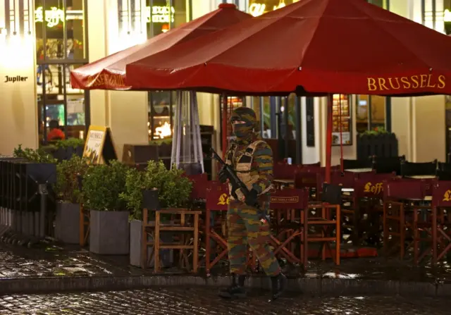 A Belgian soldier stands guard outside a cafe near Brussels' Grand Place