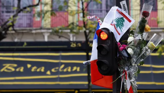 Flowers and a Tricolore left outside the Bataclan