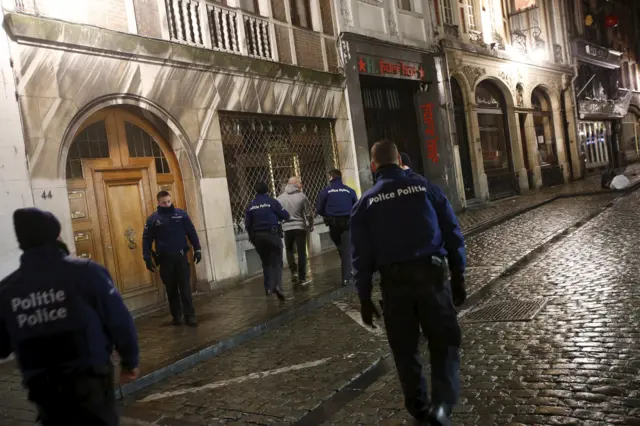 Police with a detainee in Brussels, 22 November