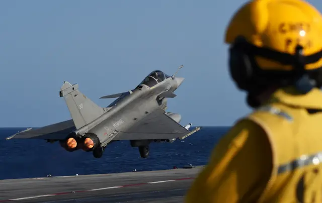 A French Rafale fighter aircraft takes off with bombs from the French aircraft carrier Charles-de-Gaulle, on 23 November 2015