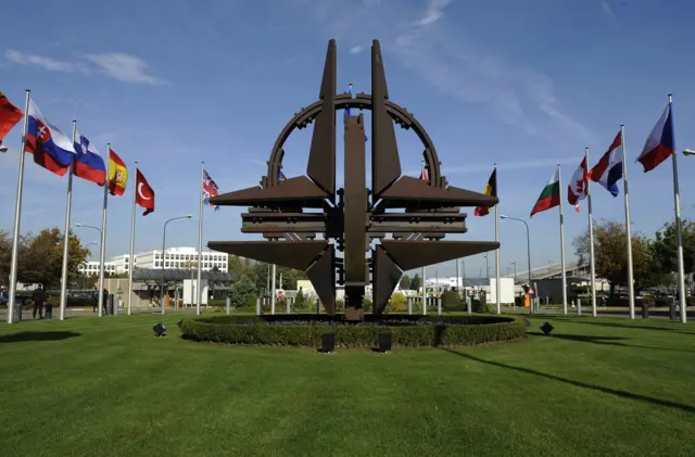 The NATO emblem is seen before a defence ministers meeting at the NATO headquarters in Brussels