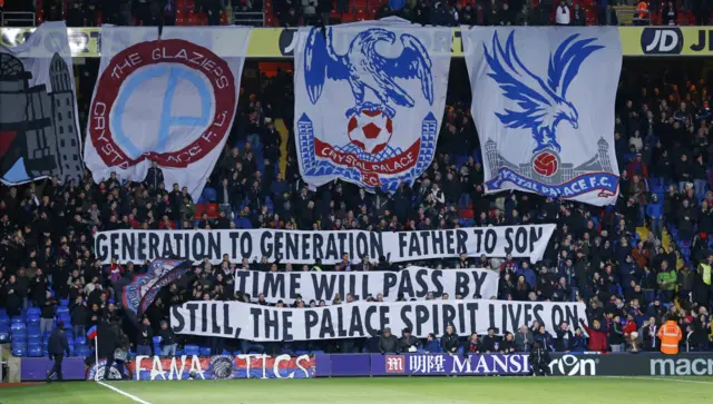 Crystal Palace fans hold banners up ahead of kick off