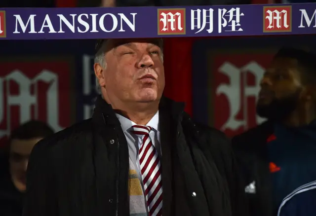 Sam Allardyce pretends to bang his head in the dugout