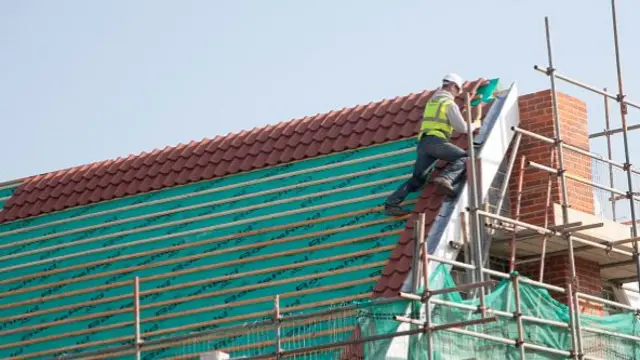 builder on a roof