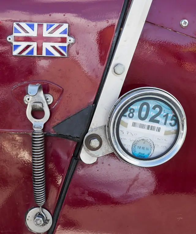 Detail of a tax disc and bonnet catch on a vintge car during the annual hill climb in Saltburn