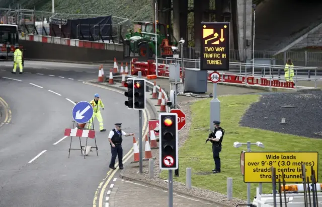 Armed police reopen road