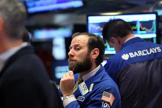 Traders work on the floor of the New York Stock Exchange