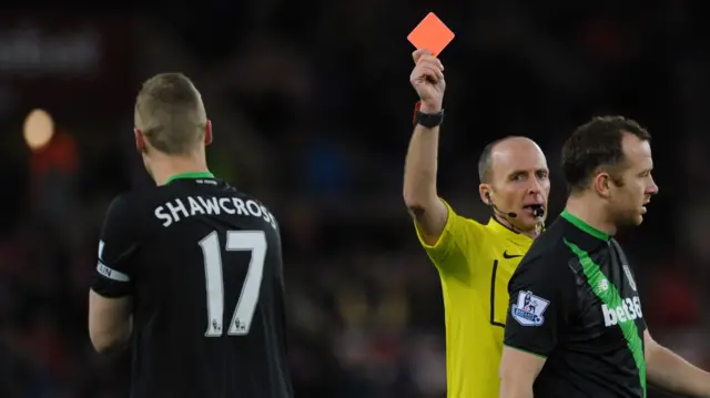 Ryan Shawcross is shown a red card