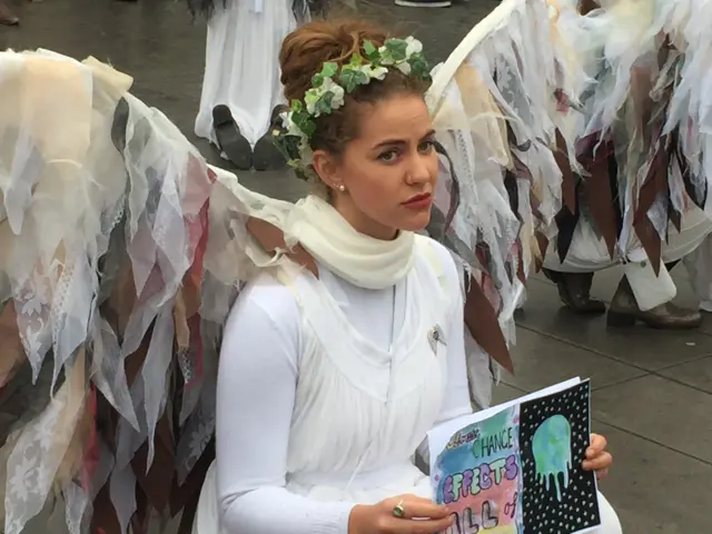 activists dressed as angels