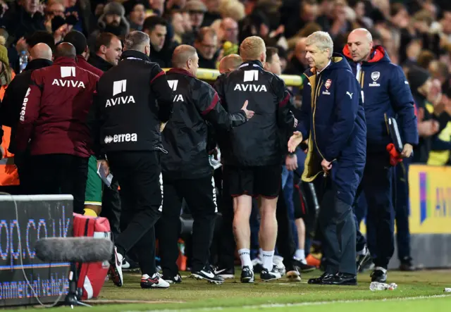 The coaching staff shake hands at full-time