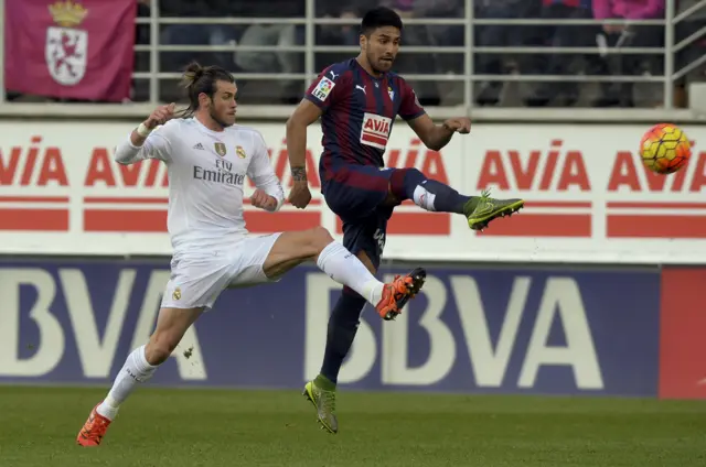 Gareth Bale challenges for the ball