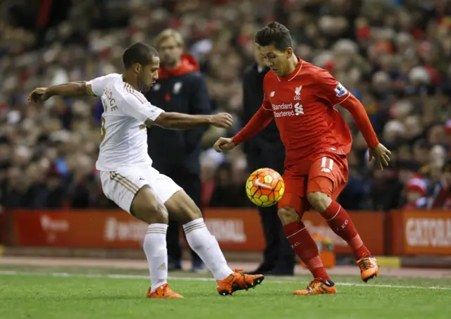 Wayne Routledge in action with Liverpool's Roberto Firmino