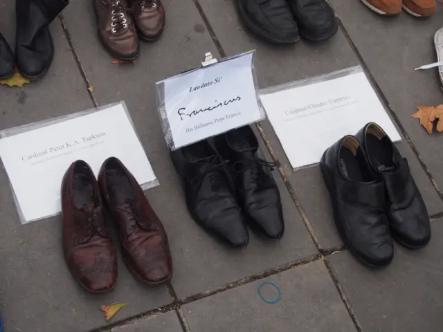 shoes from the Pope on the pavement at the Place de la Republique