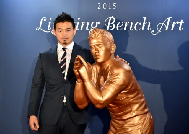 Ayumu Goromaru with his statue