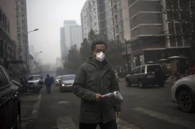 A man wears a mask on a polluted day in Beijing on November 30, 2015.