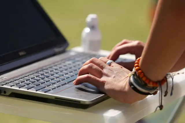 hands on a laptop