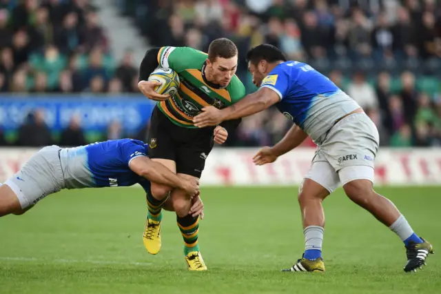 Northampton Saints' George North (centre) is tackled by Saracens' Schalk Brits (left) and Mako Vunipola (right)