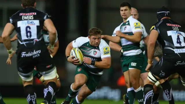 Tom Youngs (C) of Leicester Tigers runs at Mitch Lees (R) of Exeter Chiefs