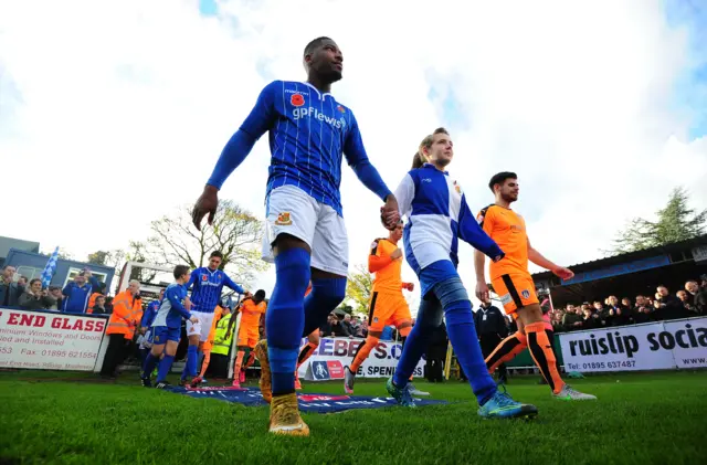 Shaun Lucien of Wealdstone walks onto the field