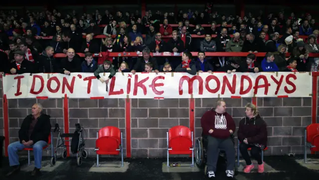 Fans display banners protesting