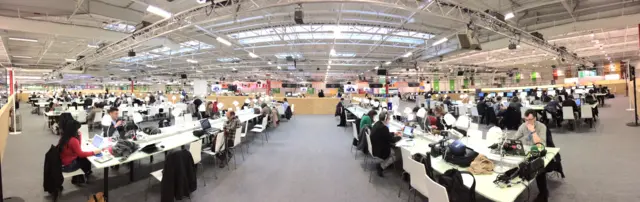 panoramic photo showing rows of desks