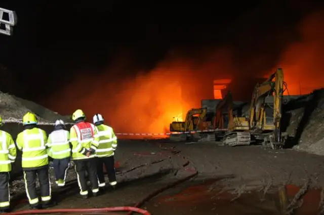 firefighters at waste recycling plant