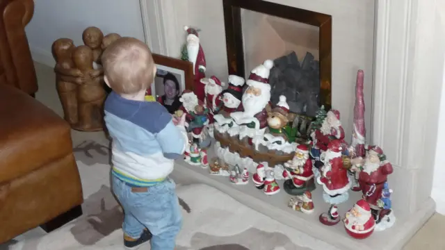 Sonny looking at Santa statues