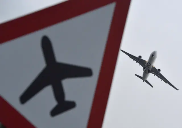 Aircraft flying over a sign