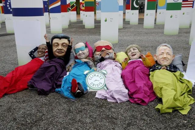 Protesters wearing large cartoon heads